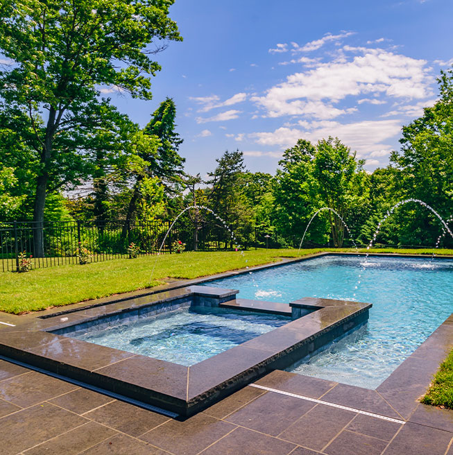 beautiful outdoor living custom pool with a jacuzzi area