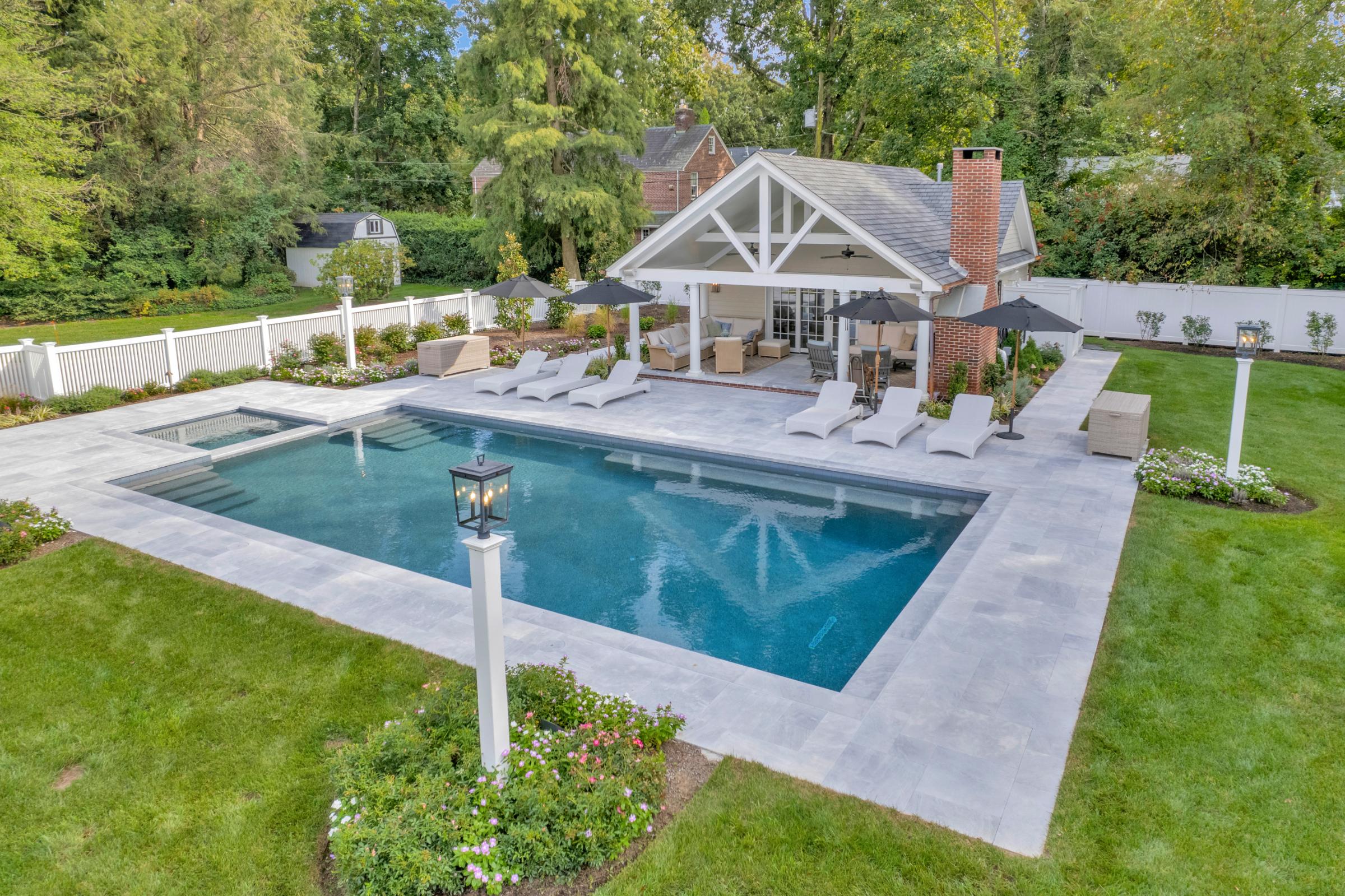 Custom pool with modern design in a spacious outdoor living area for relaxation.