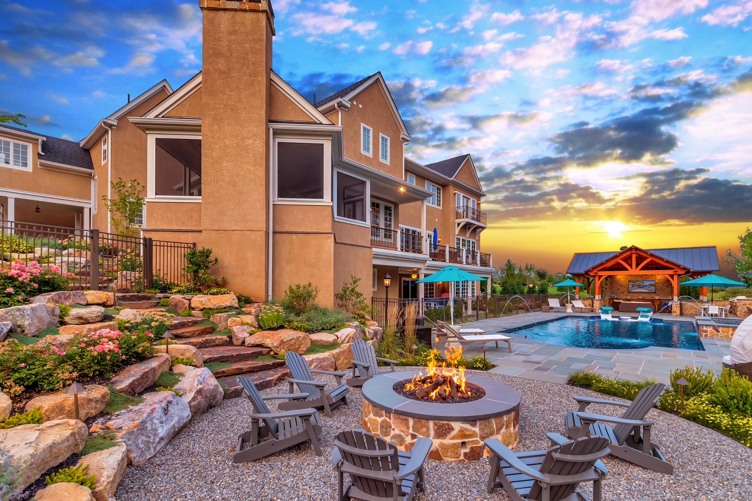 Outdoor living space featuring a custom pool, comfortable seating, and lush landscaping for ultimate relaxation.