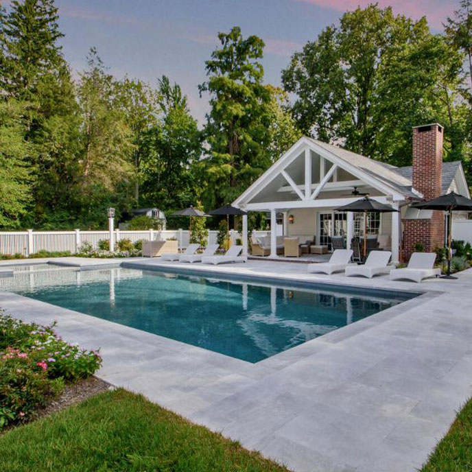 Custom pool with lush landscaping, creating a peaceful outdoor living space for relaxation.