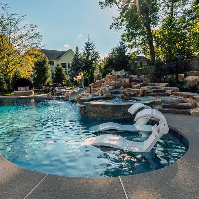 Outdoor space with a custom pool and comfortable lounge seating for family relaxation and outdoor living.