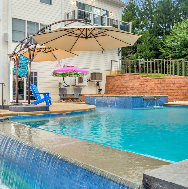 Tranquil outdoor oasis featuring a custom pool and lounge area