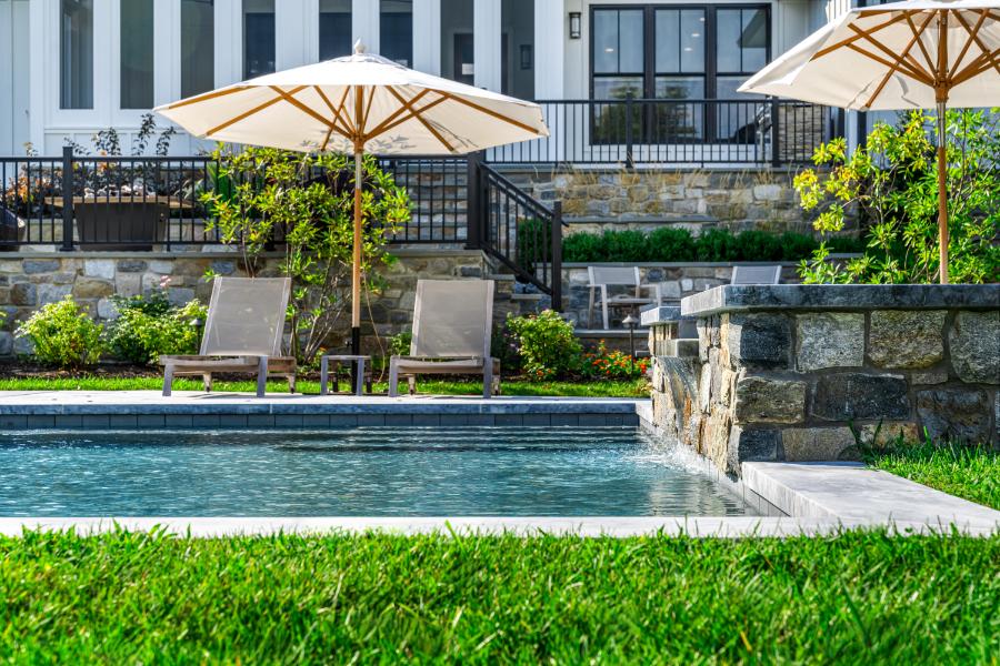 outdoor living area with sun umbrellas providing a shade for pool loungers