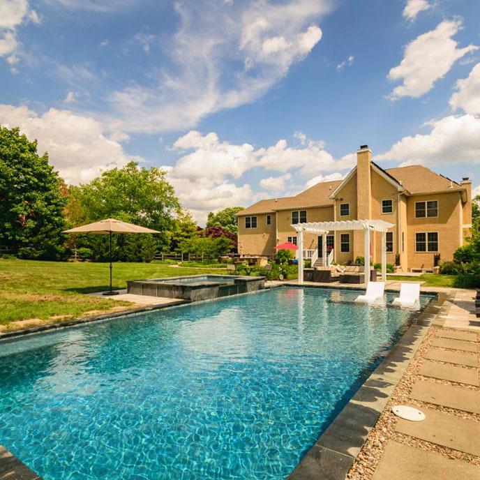 pool with raised spa, waterfall and outdoor audio system