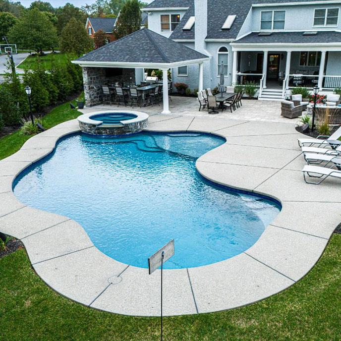 Tranquil outdoor oasis featuring a custom pool and lounge area