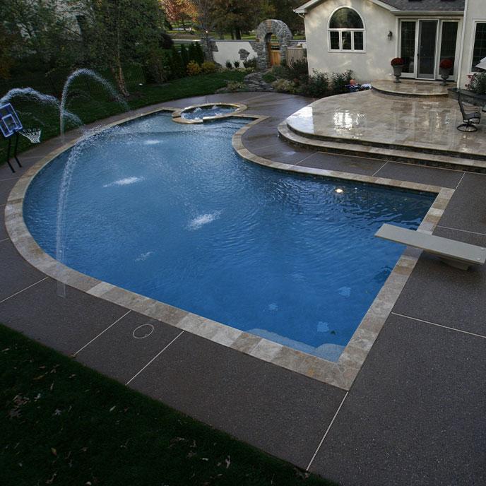 curvilinear pool with spa and diving boards