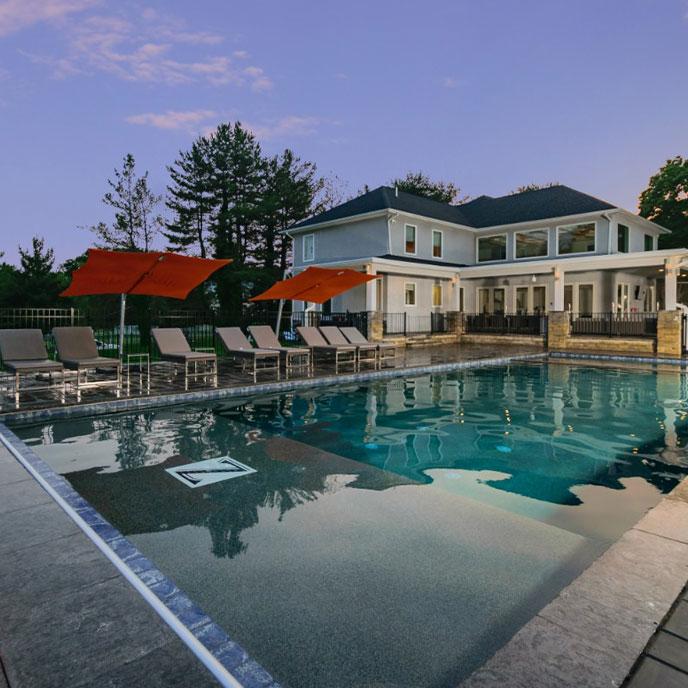 large pool with clean lines and pool house