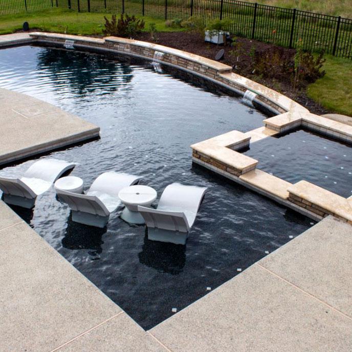 modern stone pool area with hot tub