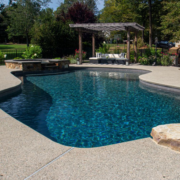 pool area with multiple lounge chairs and umbrellas