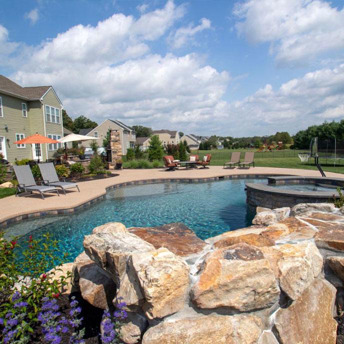 pool with hot tub and waterfall