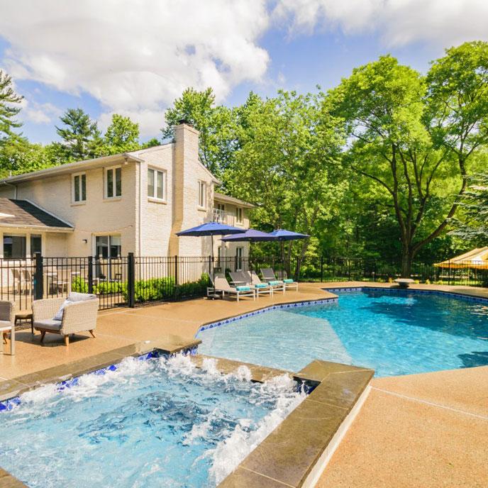 pool with tanning ledge, raised spa, diving board and fire pit