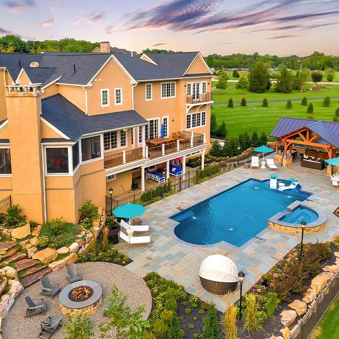 rectangular pool with water sprinklers and seating area