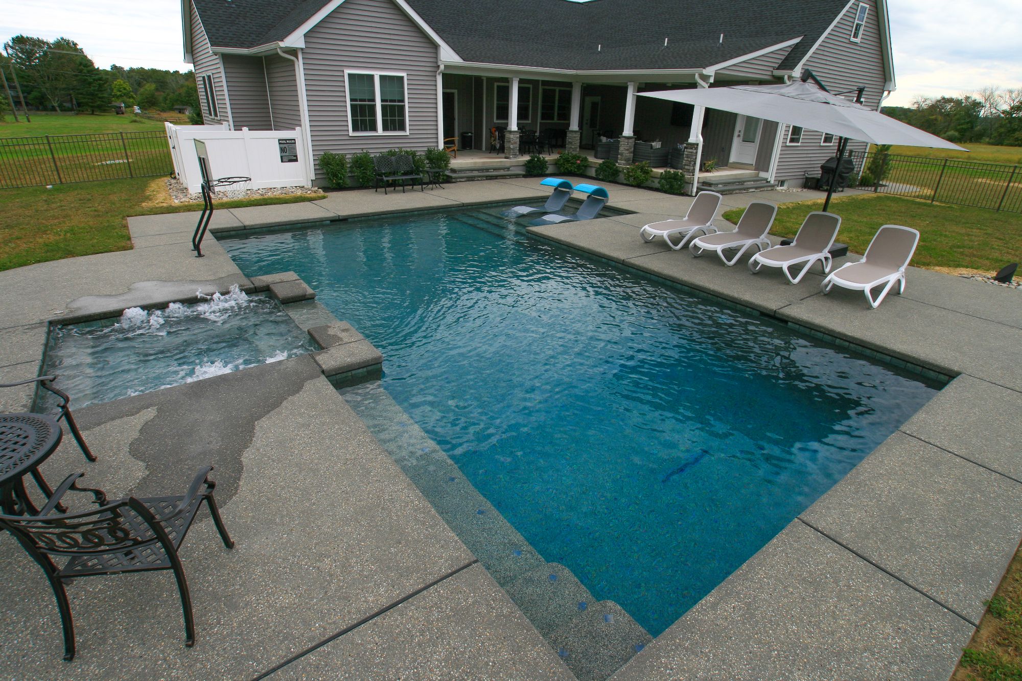 L shaped pool with hot tub