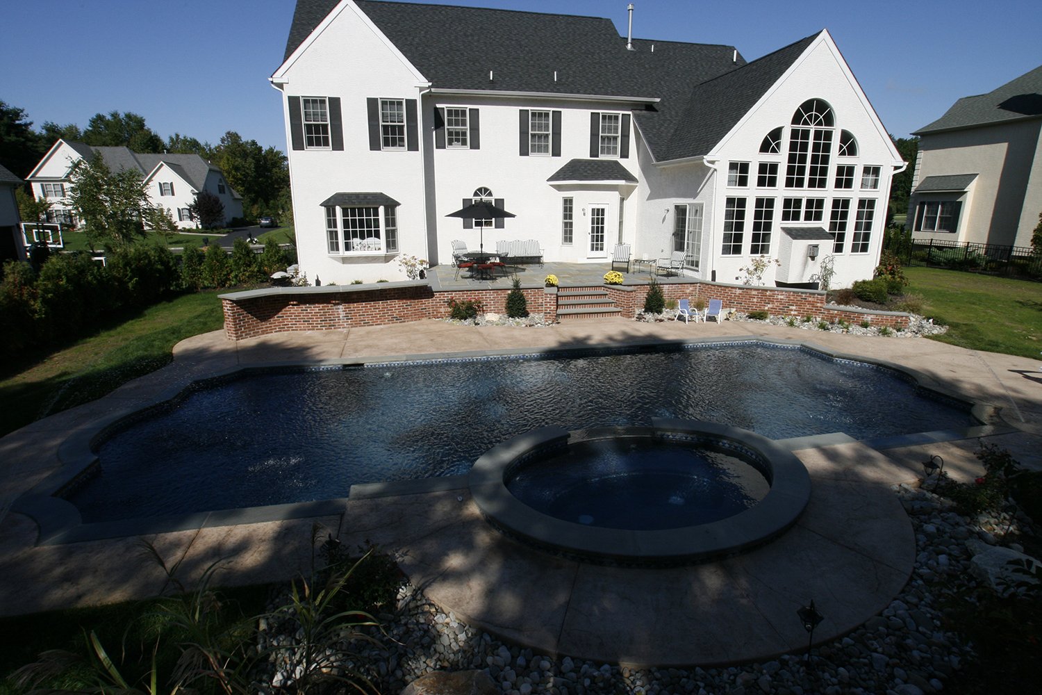 traditional pool with spa and water foundations