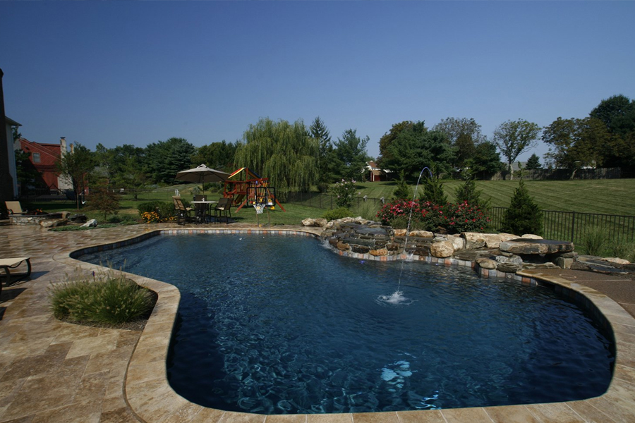 pool with rock waterfall and fire pit area