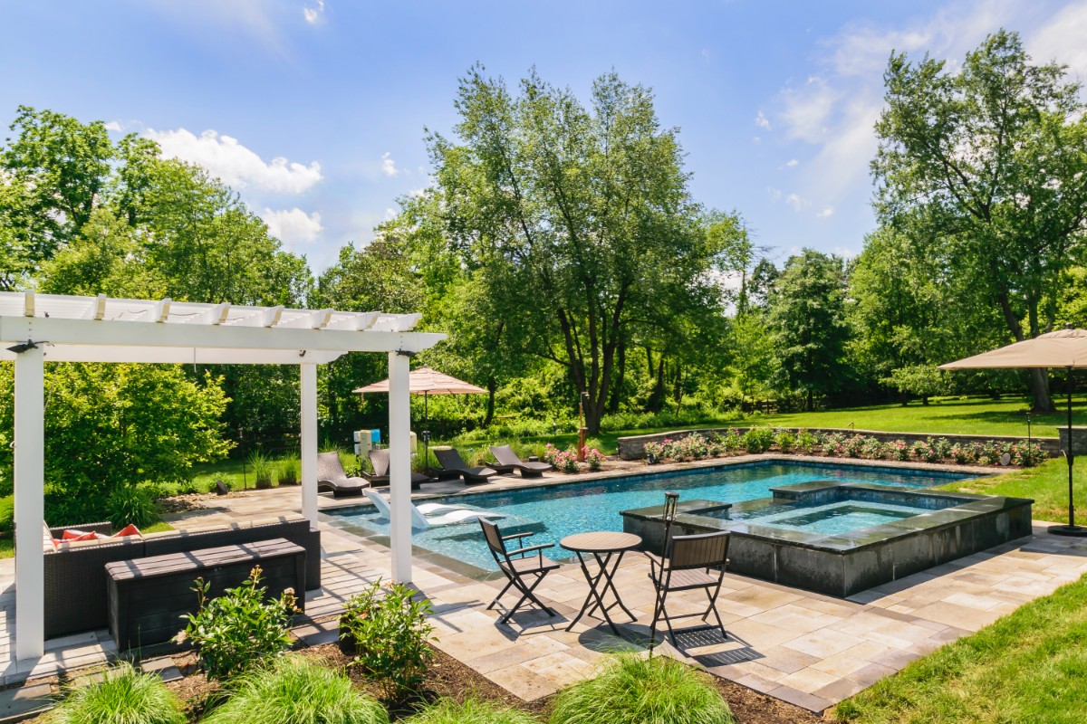 pool with raised spa, waterfall and outdoor audio system