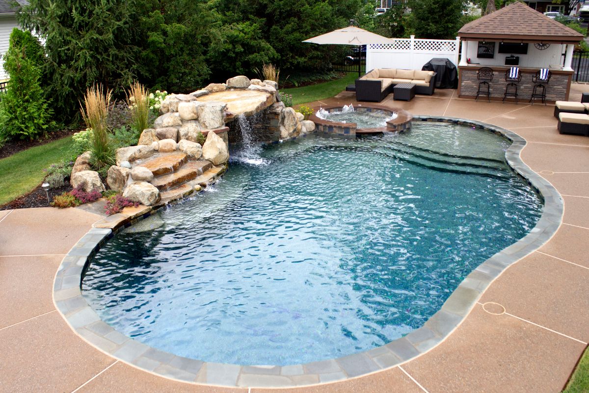 pool with spa, tanning ledge and waterfall grotto